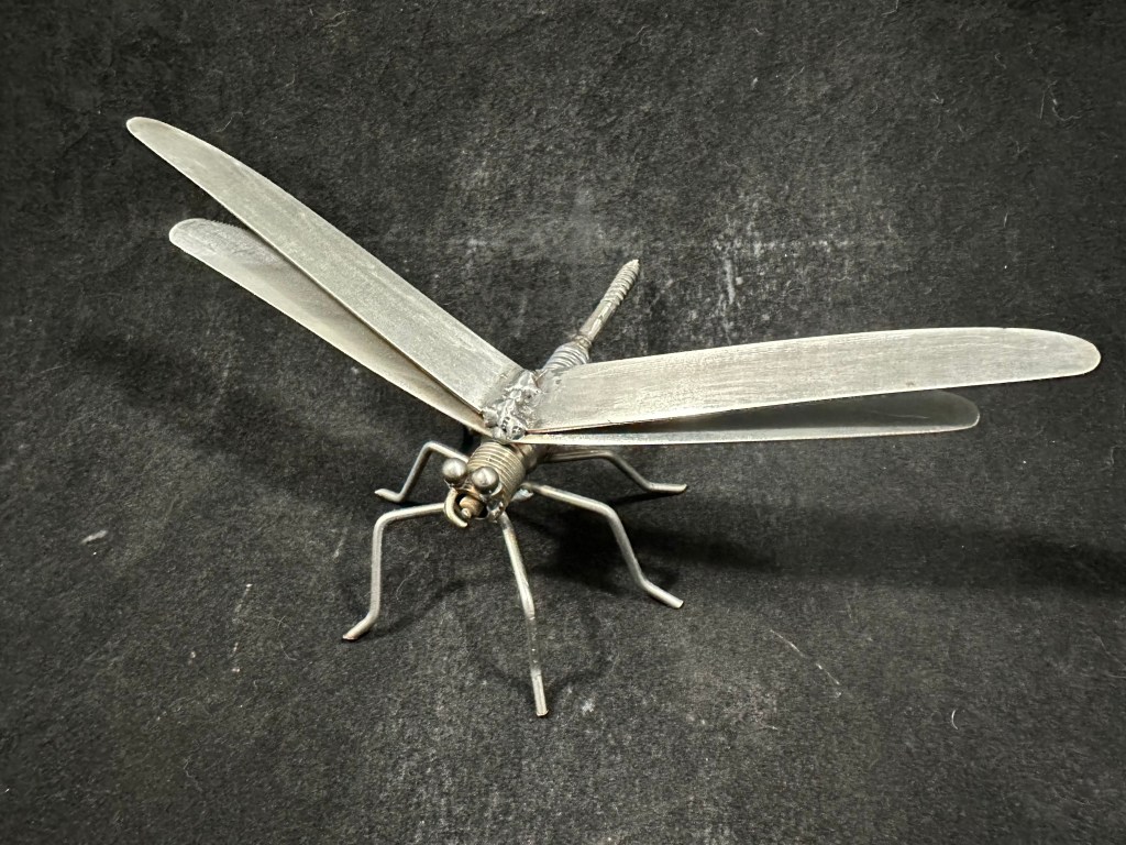 Dragonfly made from knives, a spark plug, and a screw